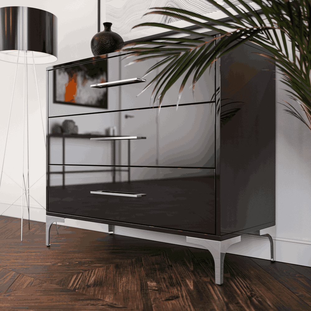 Modern black dresser with silver legs in a room setting.