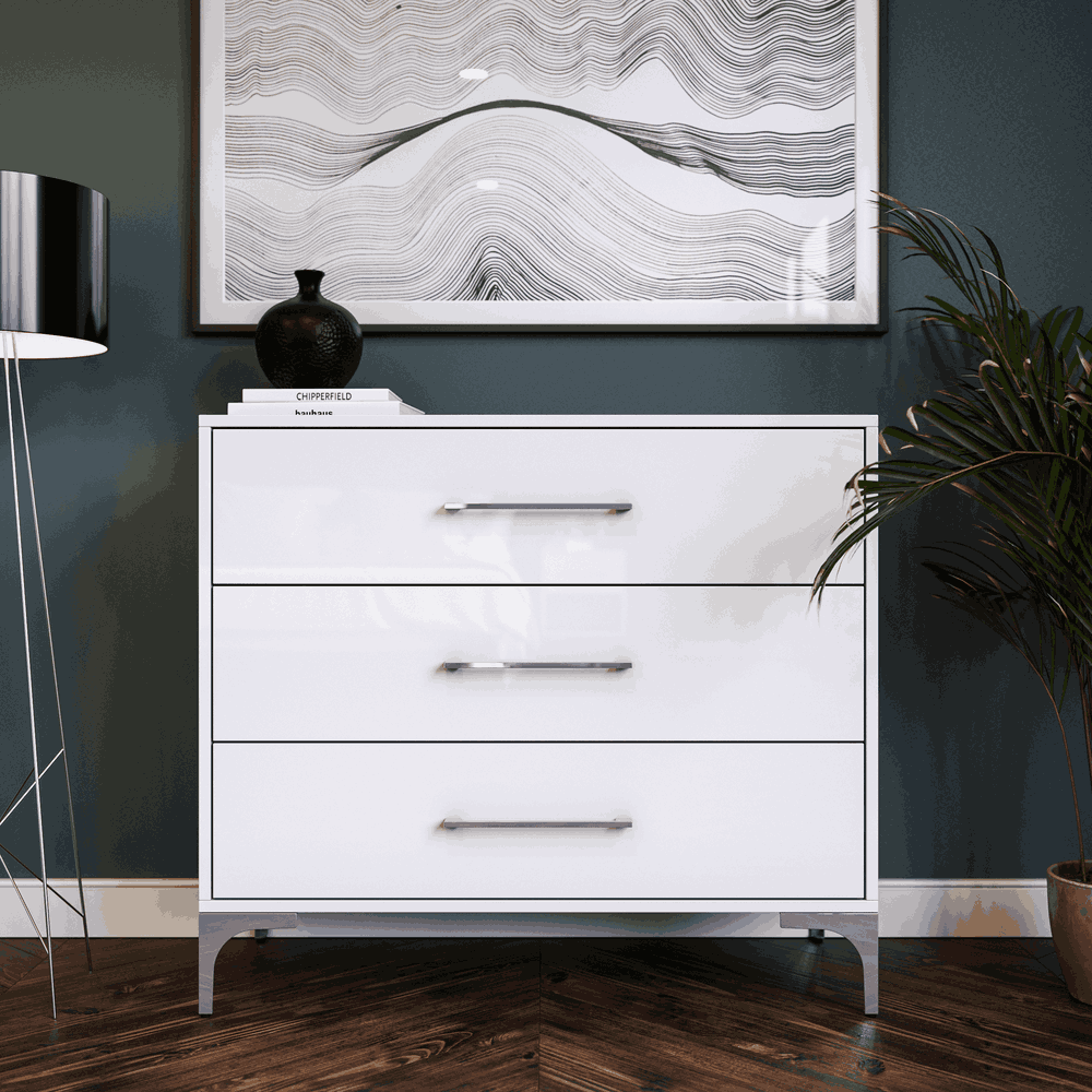 White dresser with three drawers in a room setting.