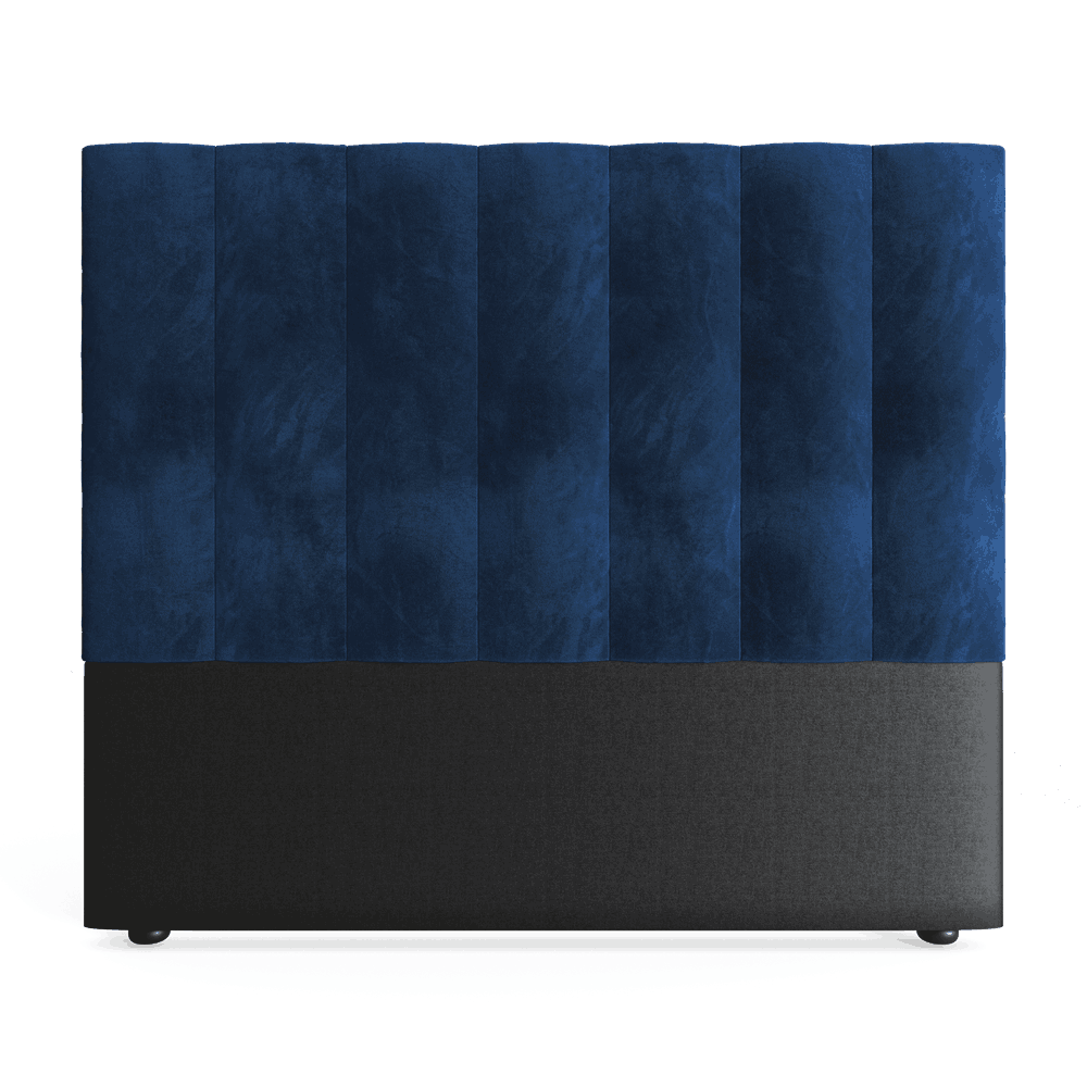 A royal blue double headboard upholstered in velvet, with a plain black base.