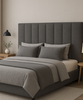 Gray upholstered bed with matching headboard and bedding in a bedroom setting.