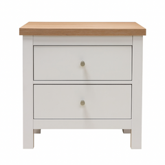 White nightstand with two drawers and a wooden top on a white background