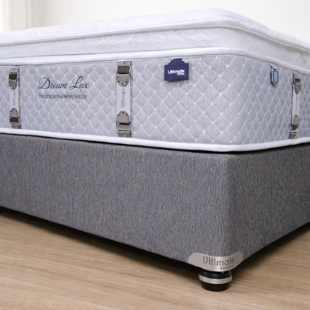 Gray mattress with 'Dream Lux' branding on a wooden floor