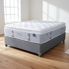 Mattress on a gray platform with a neutral background