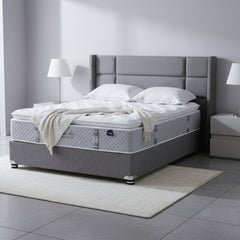 Mattress on a gray platform with a neutral background