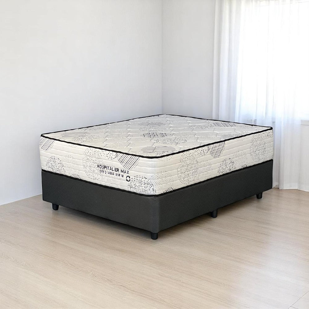 Mattress on a wooden floor with a white wall background