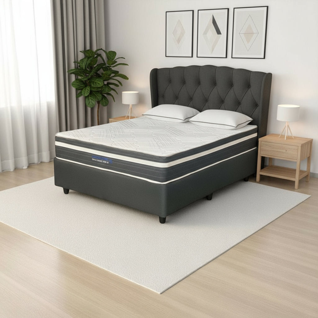 Gray mattress on a white rug in a room with curtains