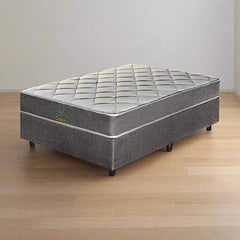 A traditional bonnell spring queen-sized mattress set on a frame, with a quilted design on the top surface.