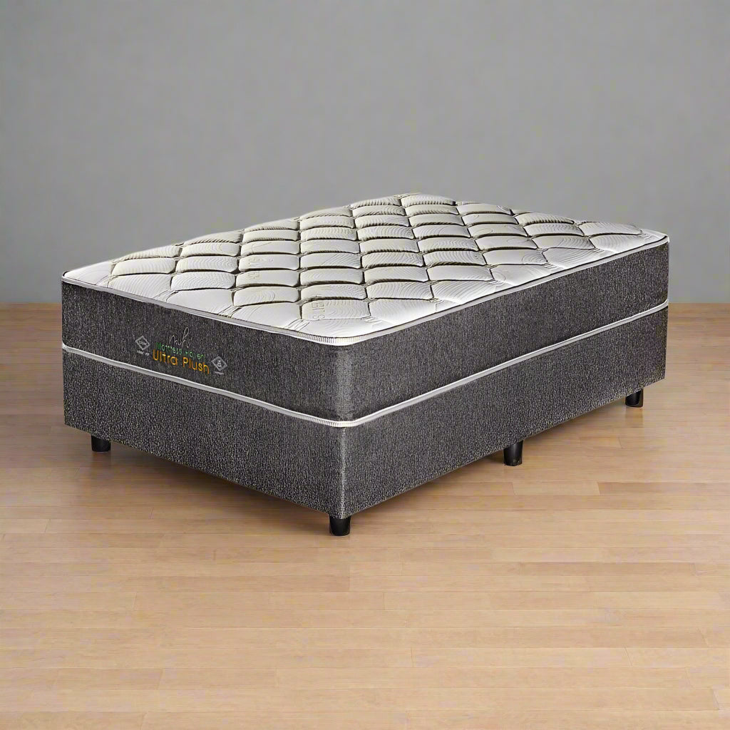 A gray and white Haven Ultra Plush queen-sized mattress on a foundation, designed for standard length beds.