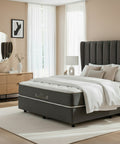 Modern bedroom with a gray upholstered bed, wooden nightstands, and a mirror.