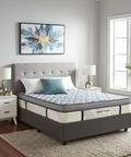 Bedroom with a mattress on a bed, nightstands, and decor