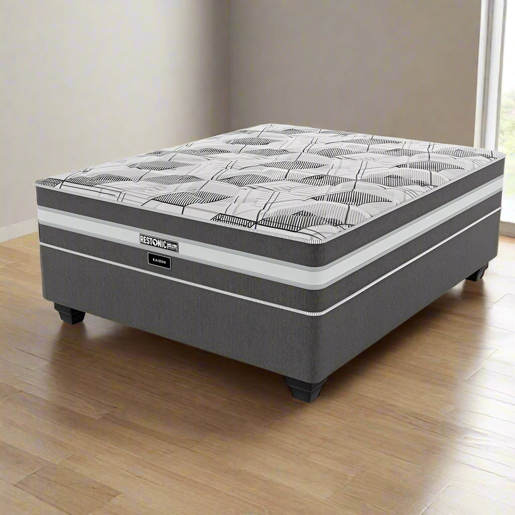 A Restonic Kaizen medium three quarter standard length bed set with a gray and white patterned mattress on a dark base.