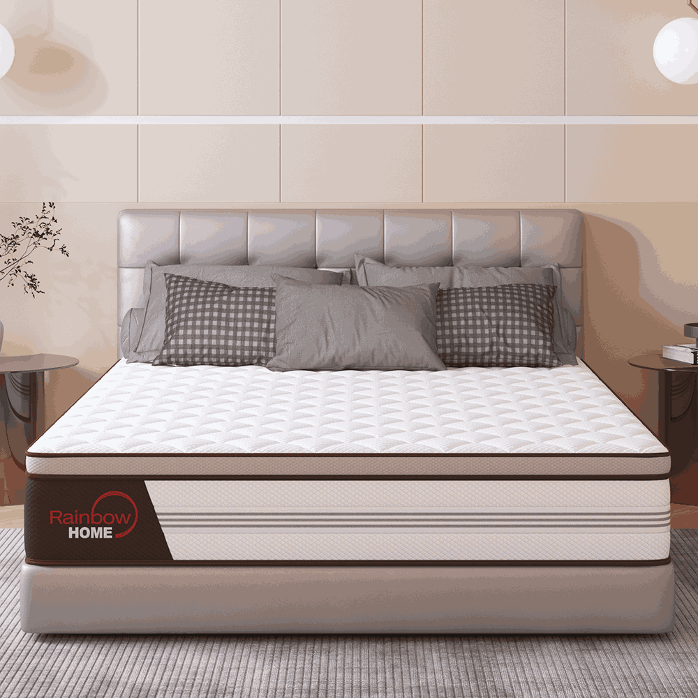 Mattress with decorative pillows on a bed in a bedroom setting, featuring the Rainbow Home brand.