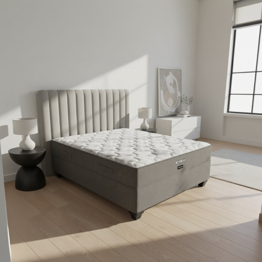 Gray upholstered bed with tufted headboard in a bedroom setting