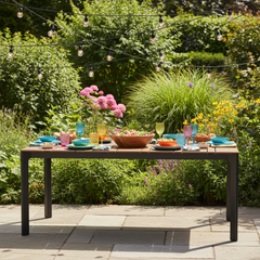 Rectangular outdoor table with wooden top and black metal legs on a white background