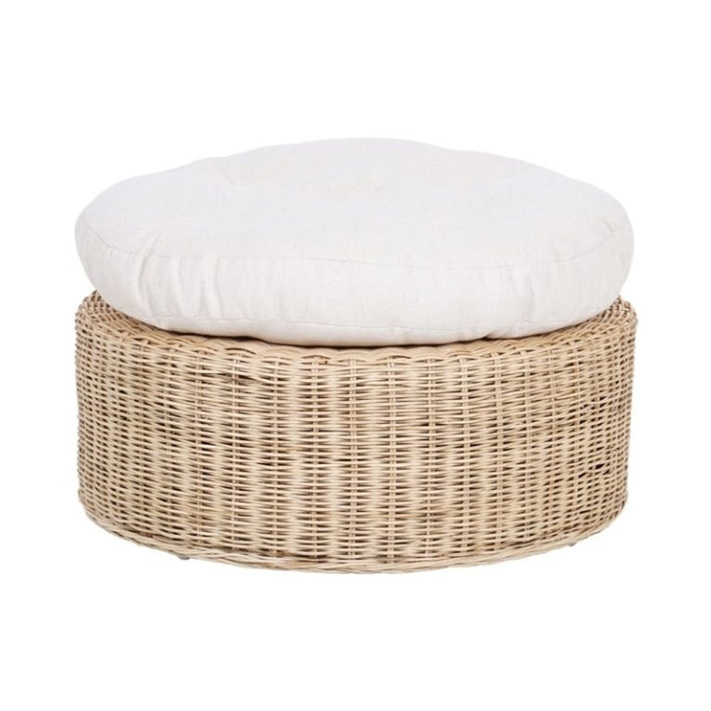 Wicker ottoman with a white cushion on a white background