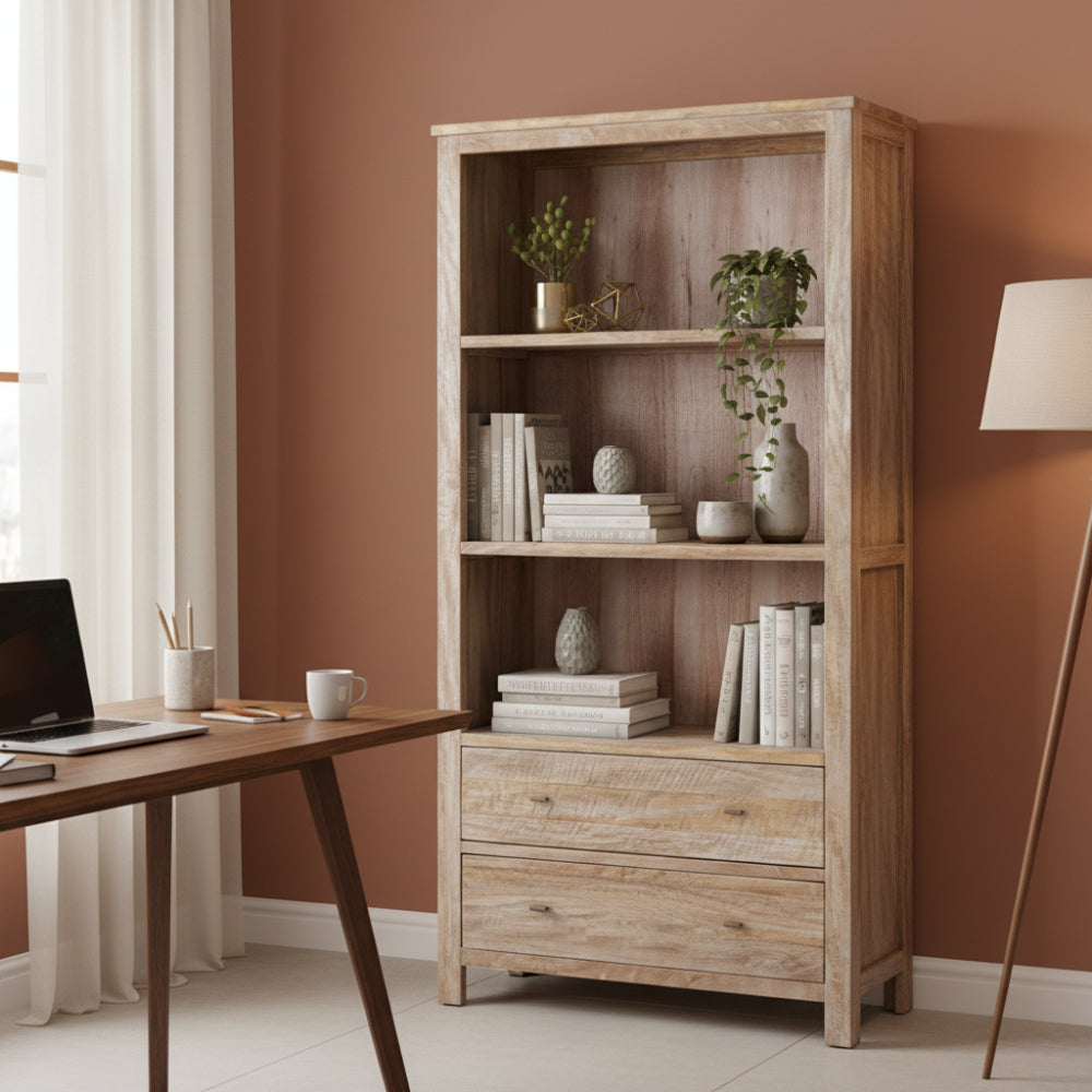 Wooden bookshelf with three shelves and a drawer on a white background