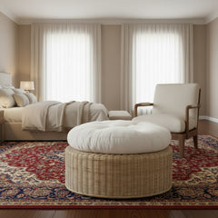Wicker ottoman with a white cushion on a white background