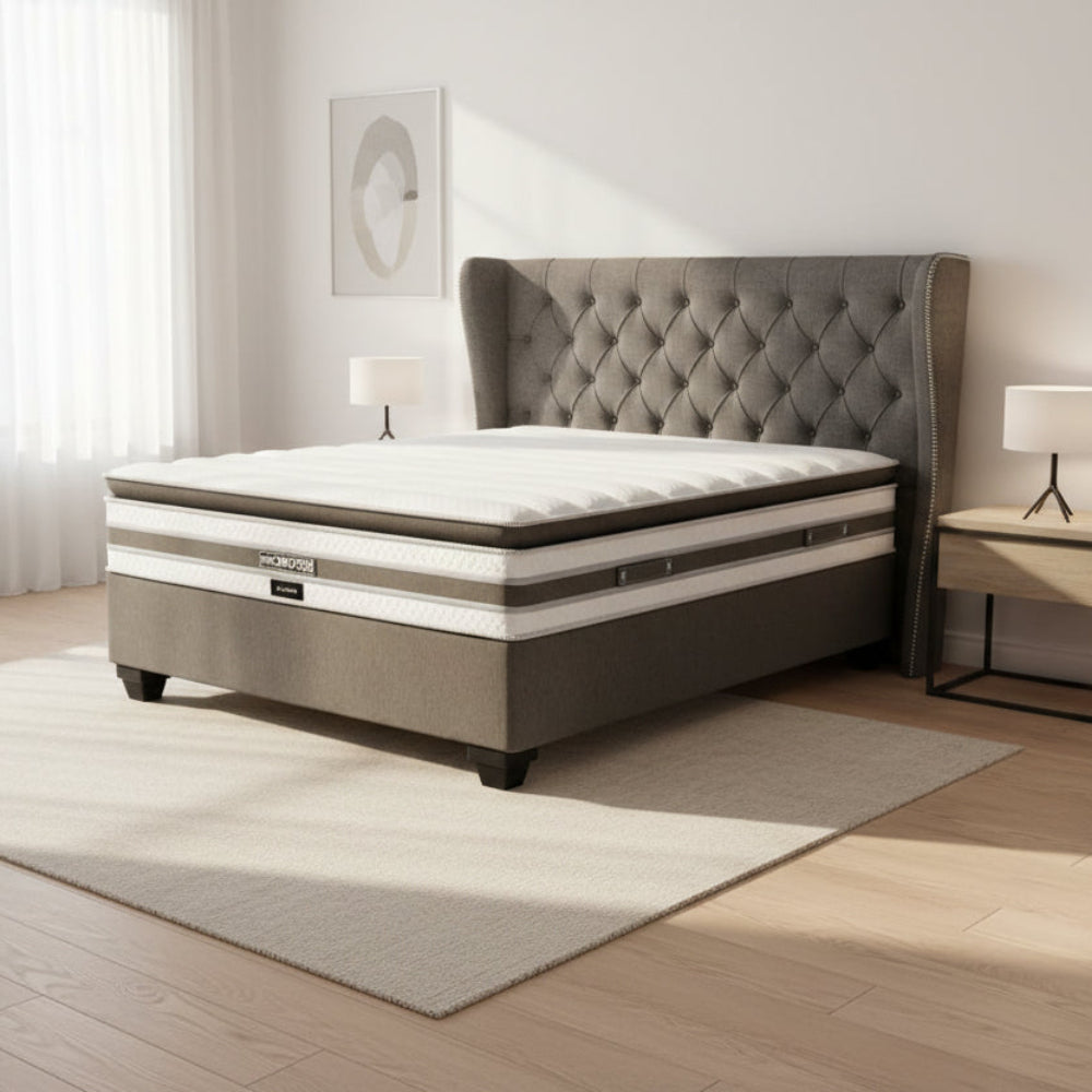 Gray and white mattress with 'Restonic' branding on a white background