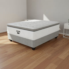 Gray mattress with a visible brand logo on a white background