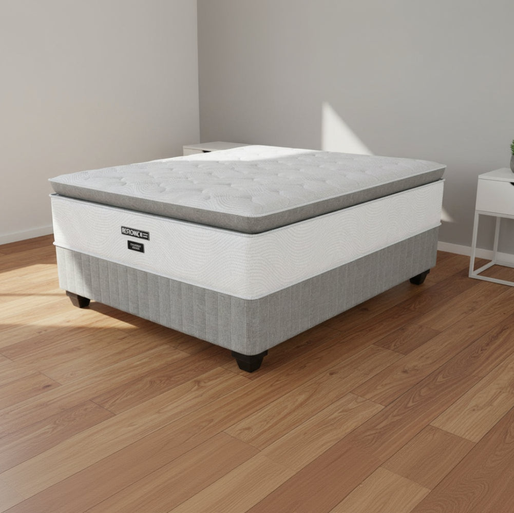 Gray mattress with a visible brand logo on a white background