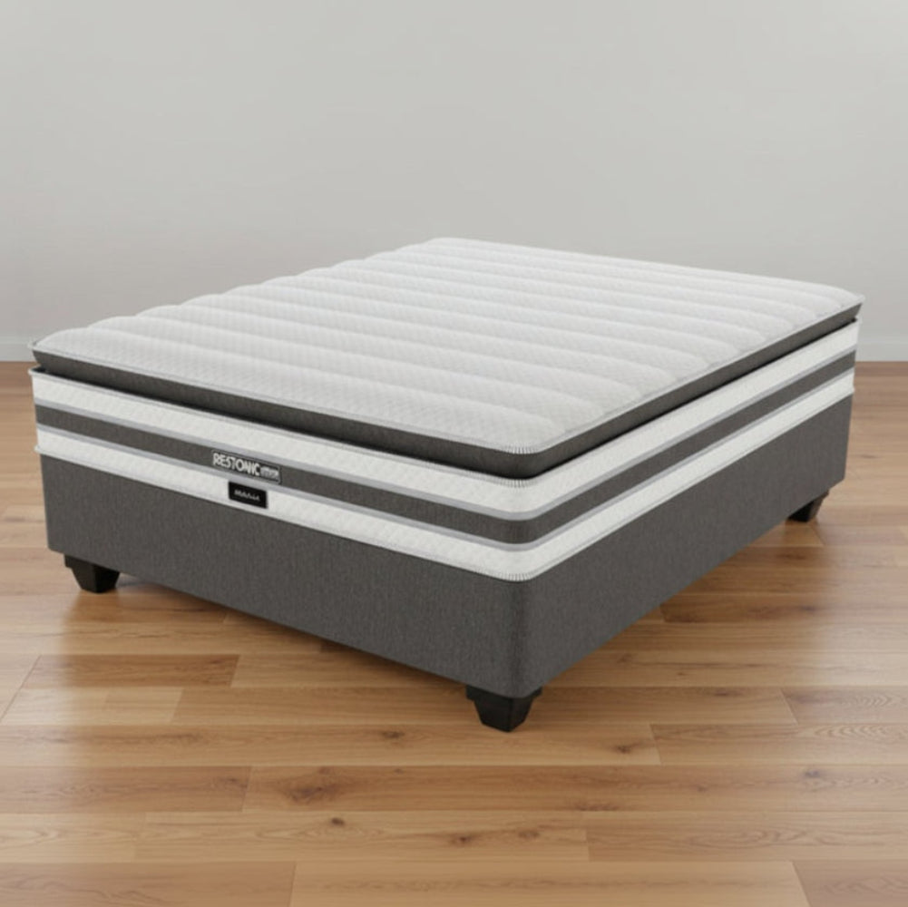 Gray mattress with visible brand name on a white background