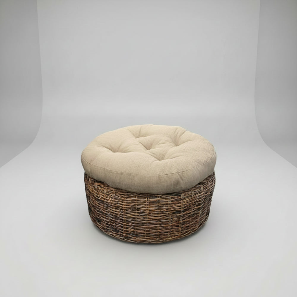 Round ottoman with woven base and beige cushion on a white background