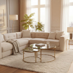Set of two round glass tables with metal frames on a white background