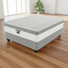Gray and white mattress with 'RESTON' branding on a white background